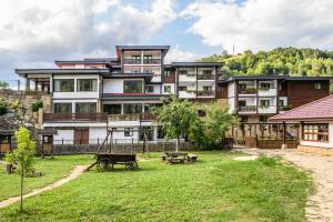 an apartment building with a park in front of it at Hotel Etar in Gabrovo