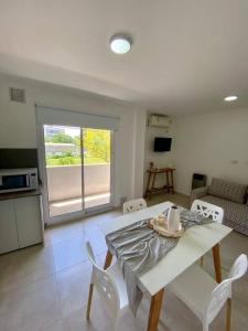 a kitchen and living room with a table and chairs at La Martina in Concepción del Uruguay