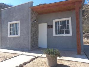 a house with a white door and two windows at Urku Wasi I in Chilecito