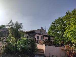 a house with a staircase leading up to it at La Rosa antica dell'Etna in Puntalazzo