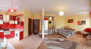a kitchen and living room with red and yellow at VIP studio in CENTER!!! in Mykolaiv