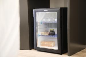 a refrigerator with its door open with food inside at Dadu Rooms in Orikum