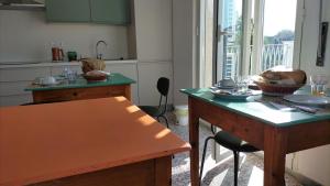 a kitchen with a table and a counter top at B&B riccidamare in Marina di Massa
