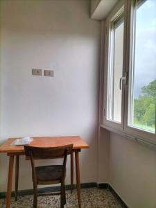 a wooden table and a chair in a room with a window at B&B riccidamare in Marina di Massa +25 photos