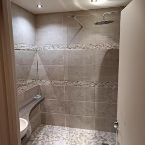 a bathroom with a shower with a toilet and a sink at Chambre chez Casa Créteil in Créteil +6 photos