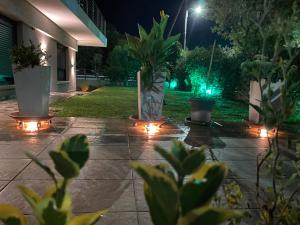 a patio at night with lights and potted plants at M+V apartment in Alexandroupoli