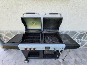 a bbq grill sitting on top of a floor at ZenHouseApartment in Ljubno