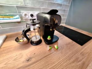 a coffee maker on a counter in a kitchen at Studio LILAS avec terrasse au calme in Montreuil +3 photos