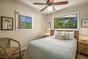 a bedroom with a bed and a ceiling fan at (HH9B) Classic Hawaiian Hale Honu 2br 2ba in Princeville