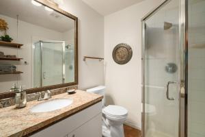 a bathroom with a toilet and a sink and a shower at (HH9B) Classic Hawaiian Hale Honu 2br 2ba in Princeville +19 photos