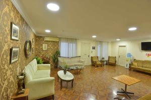 a living room with a couch and a table at Hotel Nikea Paradiso in Kutaisi