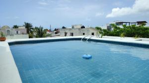 a swimming pool with a blue ball in the water at Casa Quintal - Cerca del mar in Cancún