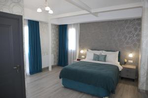 Postel nebo postele na pokoji v ubytování Hotel Saguramo Bliss