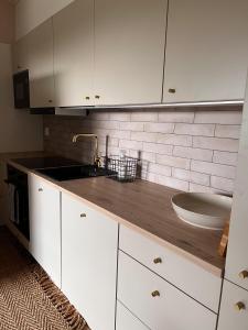 a kitchen with white cabinets and a sink at Rinneköngäs - Ruka-Pyhä 2x SKIPASS included in Ruka