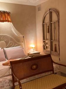 a bedroom with a bed and a table with a lamp at LE LANTERNE in Villa dʼAlmè