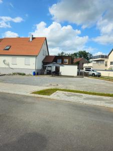 a white house with a red roof on a street at Ferienwohnung Illenschwang in Wittelshofen