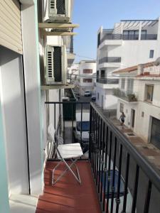 a balcony with a chair and air conditioner at Hostal Santa Calma in Marbella +6 photos