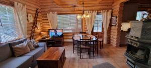 a living room with a couch and a table in a cabin at Tahko Hovimäenraitti 5A in Tahkovuori