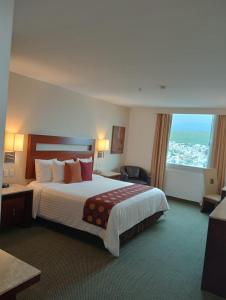 a hotel room with a large bed and a window at Hotel Ankara "Las Lomas" in San Luis Potosí