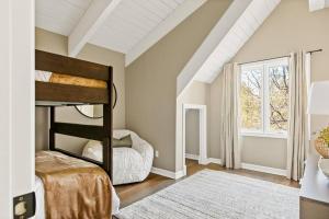a bedroom with a bunk bed and a window at Oak Mountain Retreat, Hot Tub, & BBQ, Game Room! in Lake Arrowhead +35 photos