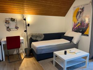 a living room with a couch and a table at Studio Wettingen möbliert, 25min bis Zürich in Wettingen