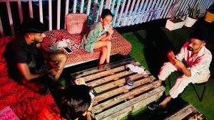 a group of people sitting in a living room at Madpackers Rishikesh Laxman Jhula in Rishīkesh
