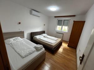 a bedroom with two beds and a window at Ilidza Apartments in Sarajevo