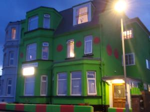 a green house with a street light in front of it at Ash Hotel B&B in Exmouth