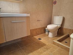 a bathroom with a toilet and a sink at Garden House KRISTI in Possidi