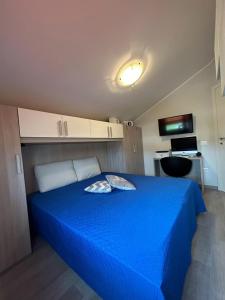 a bedroom with a blue bed in a room at AIDO living house in San Giovanni Teatino