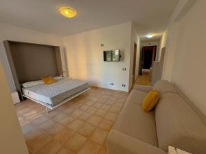 a living room with a couch and a bed at Marchetti Home in Pantelleria +30 photos