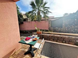 a table and two chairs on a patio at Marchetti Home in Pantelleria