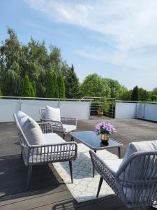 a patio with chairs and a table on a deck at Stilvolle Studiowohnung mit Sonnenterasse in Rheda-Wiedenbrück +20 photos