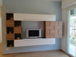 a television sitting on a shelf in a room at La conchiglia, air conditioning and parking in Rapallo