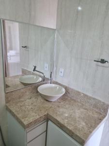a bathroom with two sinks and a large mirror at Casa Maciel in São Thomé das Letras +23 photos
