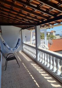 a hammock on the balcony of a house at Casa Maciel in São Thomé das Letras