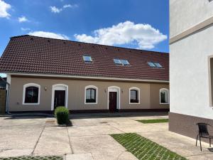 a large house with a red roof at Penzion Mánes in Krabčice