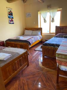 Postel nebo postele na pokoji v ubytování Casa Hotel Loma Wasi en Cotacachi
