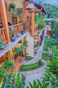 an apartment building with a courtyard with potted plants at Hotel Itzae in Copán Ruinas