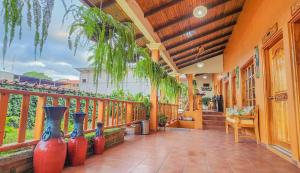 a row of vases sitting on a balcony at Hotel Itzae in Copán Ruinas