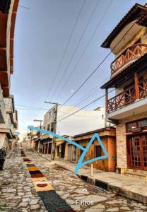 a blue ribbon on a street in a city at Hospedaria Coração de Pedra in São Thomé das Letras +20 photos