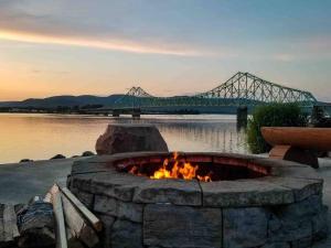 a fire pit with a bridge in the background at Downtown Campbellton Loft in Campbellton