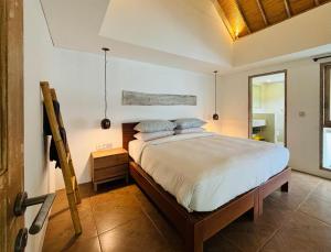 a bedroom with a large bed in a room at The Loft Villas Echo in Canggu
