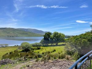 a view of a lake from a balcony at Old lake house in Gortatlea