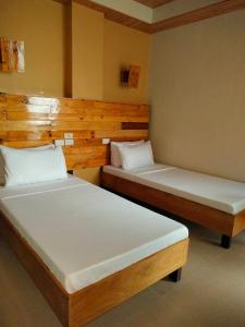 Postel nebo postele na pokoji v ubytování GHIELLANIQA INN