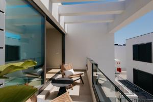 a balcony with a glass railing and a table and chairs at Marbades, Tu relax en abades in Santa Cruz de Tenerife