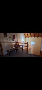 a living room with a table and a bench at Alojamiento Turístico Barrio Belgrano in San Carlos de Bariloche
