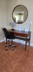 a desk with a chair and a mirror at Experience Cruzan Comfort in Christiansted +19 photos