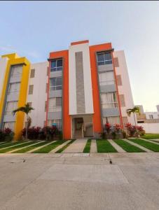 a large building with palm trees in front of it at Departamento con 2 Recamaras in La Sabana