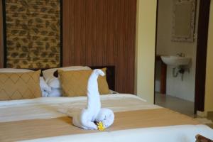 Postel nebo postele na pokoji v ubytování Alit Bungalow Ubud